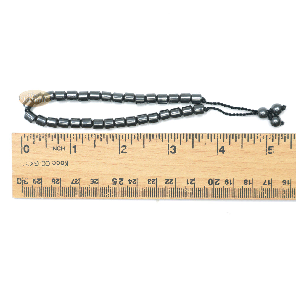 Black cylindrical-bead Islamic tasbih bracelet with adjustable cord.