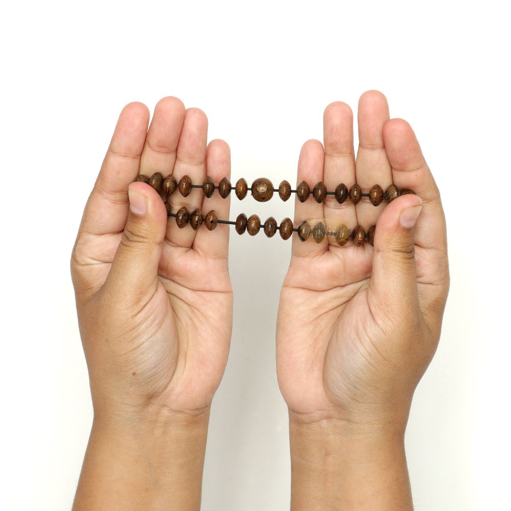Natural brown wooden tasbih bracelet with oval beads arranged on an elastic band.