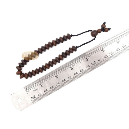 Brown wooden tasbih bracelet with adjustable braided cord.