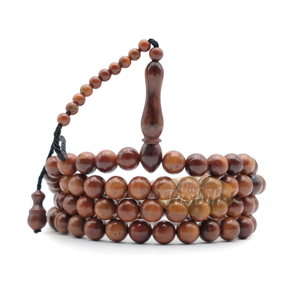 Brown wooden Islamic misbaha prayer beads with 99 beads and a black tassel cord.