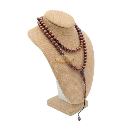 Brown wooden Islamic misbaha prayer beads with 99 beads and a black tassel cord.