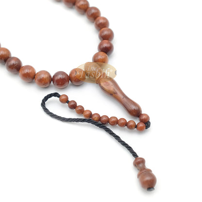 Brown wooden Islamic misbaha prayer beads with 99 beads and a black tassel cord.