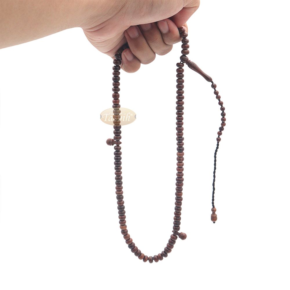 Brown wooden Islamic misbaha with rounded prayer beads and a black tassel cord.