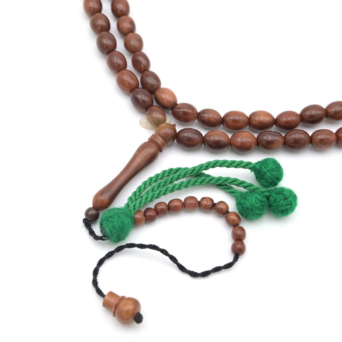 Brown wooden Islamic misbaha prayer beads with elongated oval beads and green tassels.