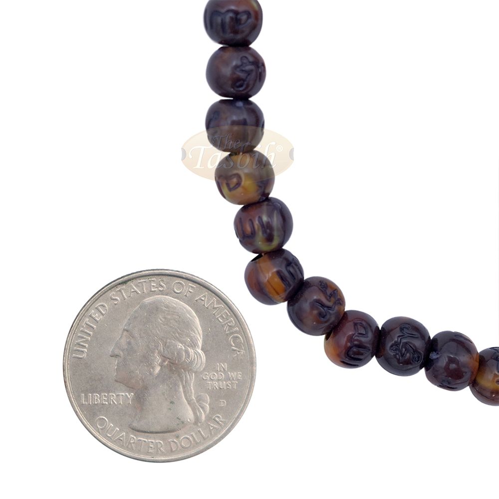 Brown and black patterned wooden Islamic misbaha prayer beads with braided tassel cord.