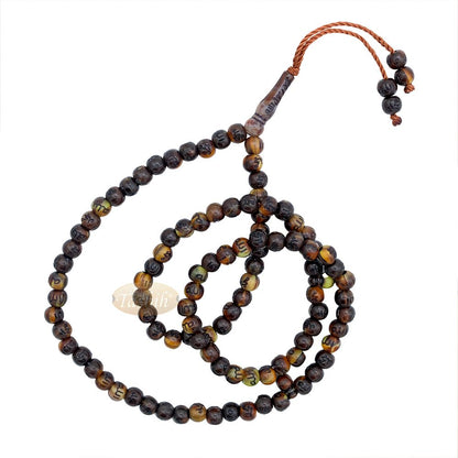 Brown and black patterned wooden Islamic misbaha prayer beads with braided tassel cord.